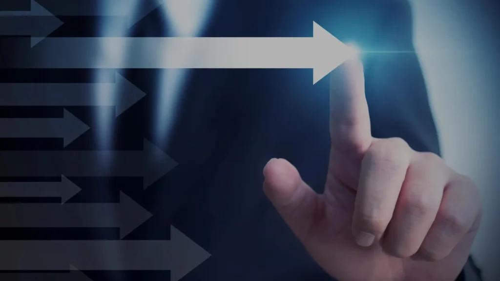 Businessman pointing at an upward growth arrow on a screen