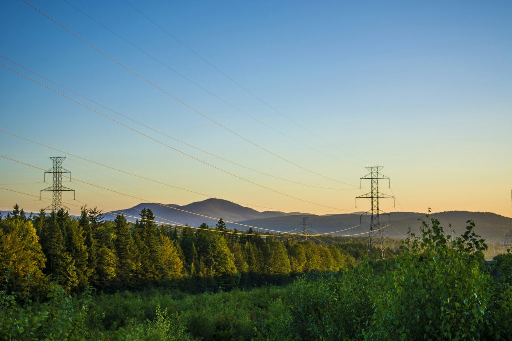 Transmission tower at dusk in a natural landscape