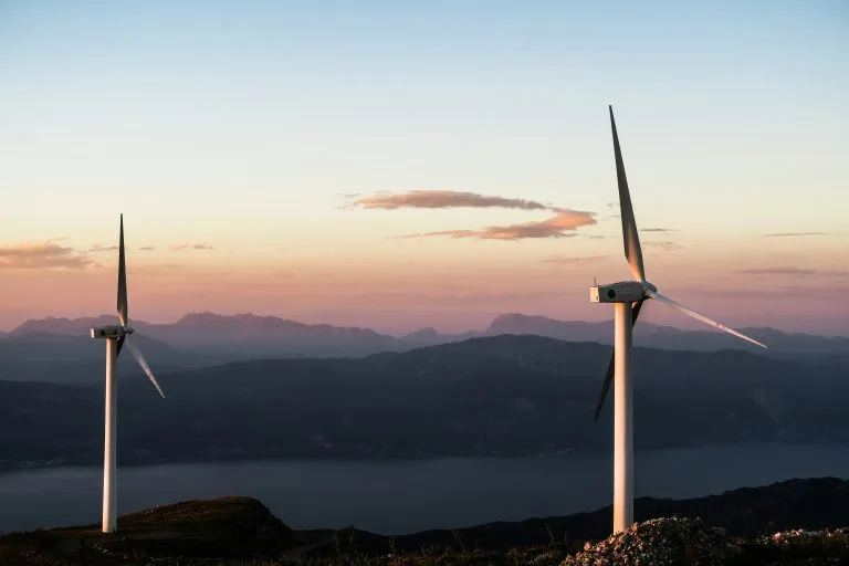 Wind turbines on mountain at dusk