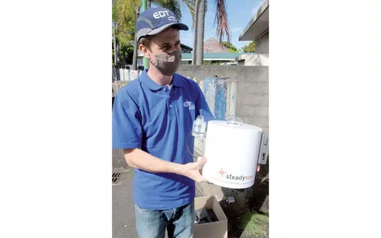 Former SteadySun member holding SteadyEye sky imager